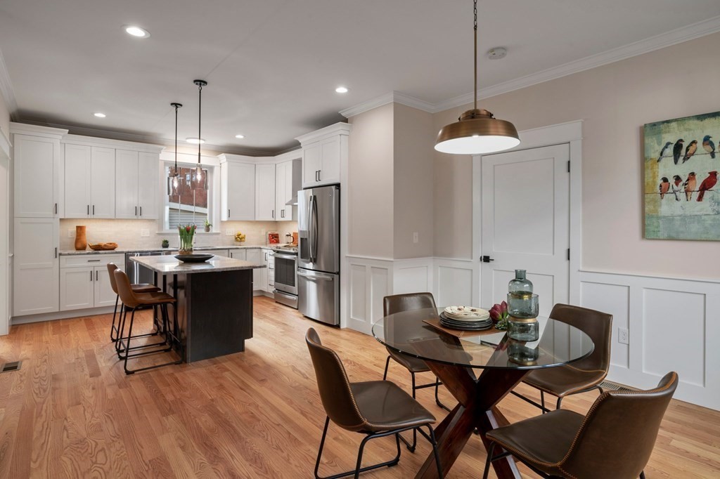 297 Riverside Drive Northampton, MA 01062 - Photo 7 of 32 a kitchen with granite countertop a dining table chairs and refrigerator