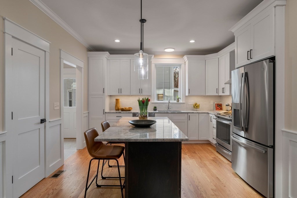 297 Riverside Drive Northampton, MA 01062 - Photo 9 of 32 a kitchen with refrigerator cabinets and wooden floor