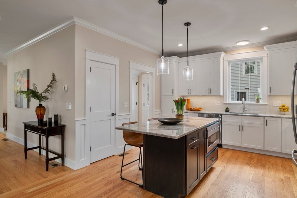 297 Riverside Drive Northampton, MA 01062 - Photo 10 of 32 a kitchen with kitchen island a sink dining table and chairs