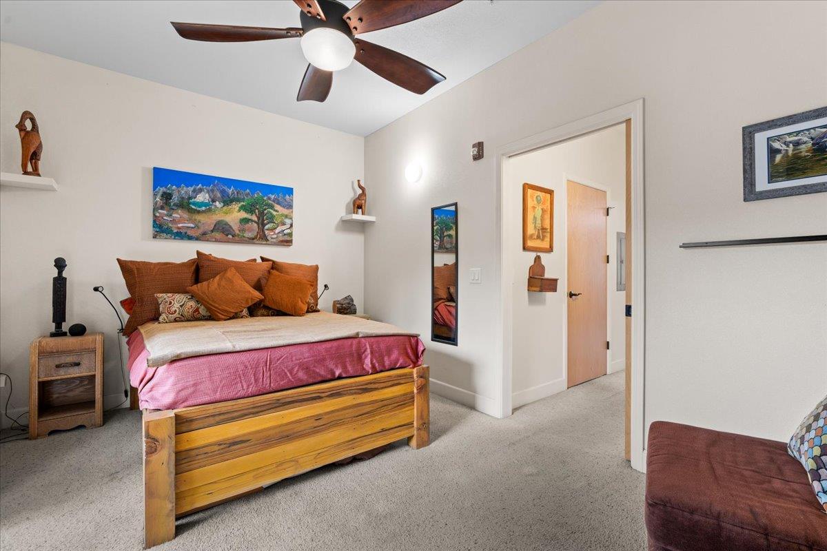 800 Freeman Lane, Unit 105 Grass Valley, CA 95949 - Photo 12 of 48 a bedroom with bed and a chandelier