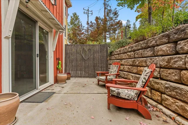 a backyard of a house with barbeque oven and outdoor seating