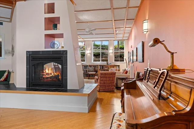 a living room with furniture a fireplace and wooden floor