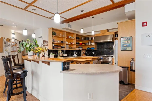 a kitchen with stainless steel appliances a stove a sink and a refrigerator