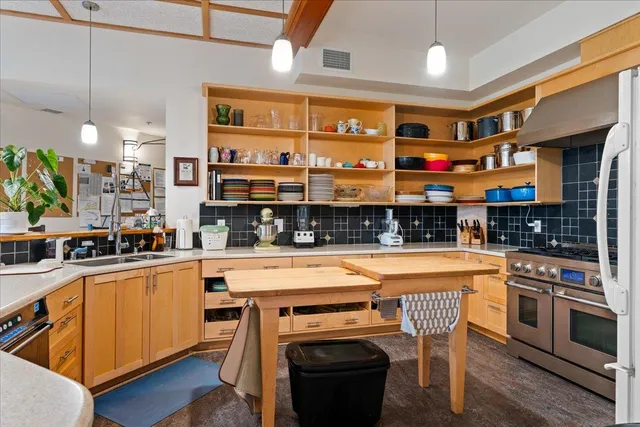 a kitchen with stainless steel appliances granite countertop a stove and a sink