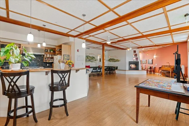 a dining room with furniture and a floor to ceiling window
