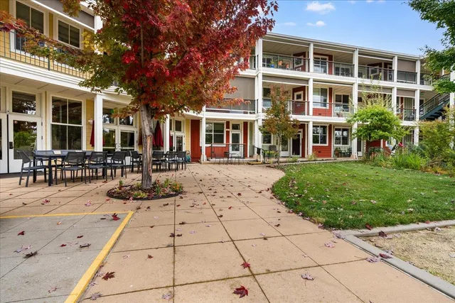 a view of a building with a bench in front of house