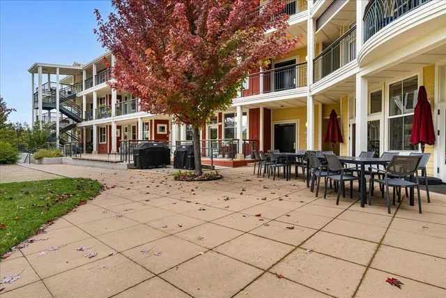 a view of a building with a bench in a patio