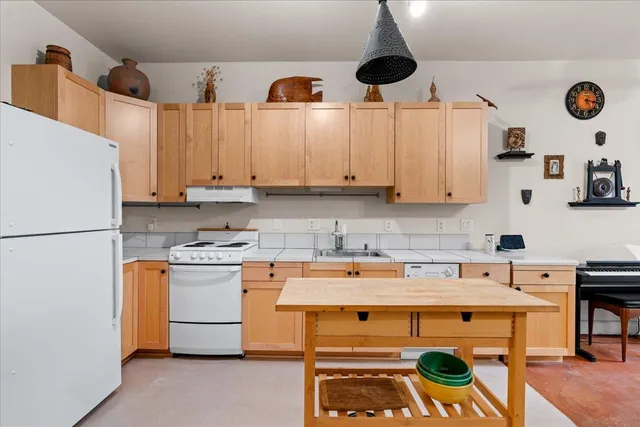 a kitchen with stainless steel appliances a stove a refrigerator and a sink