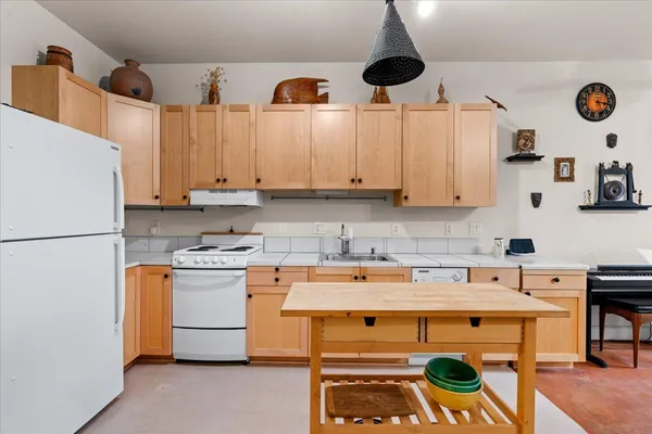a kitchen with stainless steel appliances a stove a refrigerator and a sink