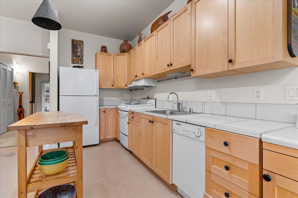 800 Freeman Lane, Unit 105 Grass Valley, CA 95949 - Photo 9 of 48 a kitchen with stainless steel appliances granite countertop a sink and cabinets