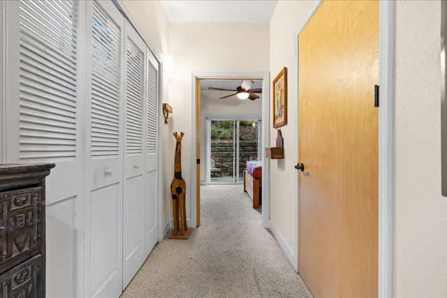a view of a hallway with wooden shelves
