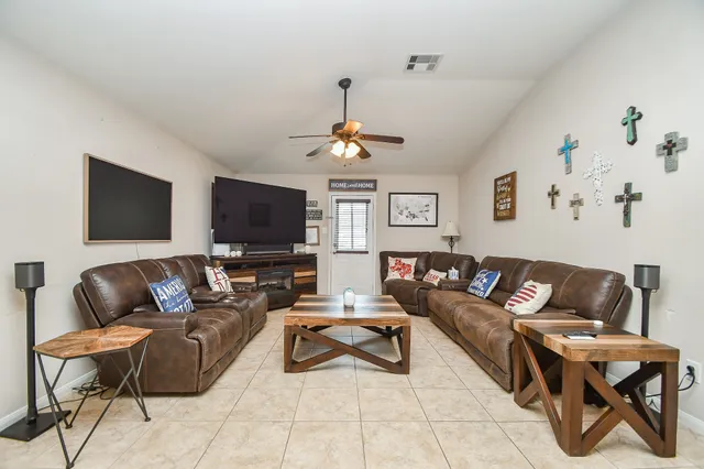 a living room with furniture and a flat screen tv