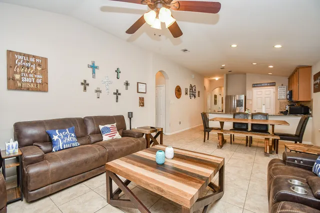 a living room with furniture and kitchen view