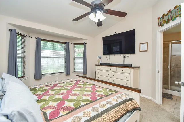 a bedroom with a bed and a flat screen tv