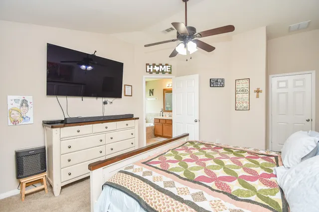 a bedroom with a bed and a flat screen tv