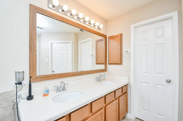 a bathroom with a sink vanity and a mirror