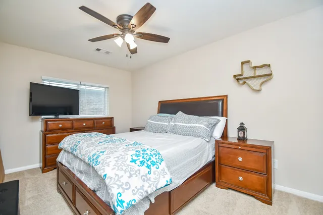 a bedroom with a bed and a flat screen tv