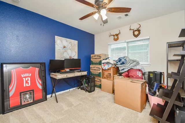 a view of a workspace with furniture and a window