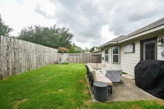 a view of backyard of house with seating space