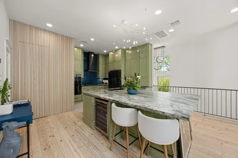 a kitchen with stainless steel appliances granite countertop a stove and a wooden floors