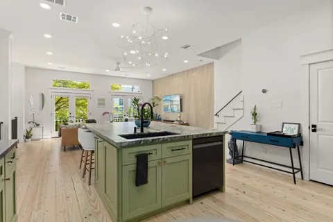 a kitchen with stainless steel appliances granite countertop a refrigerator and a stove top oven