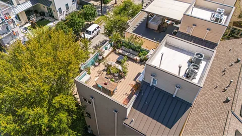 an aerial view of a house with a yard and sitting area