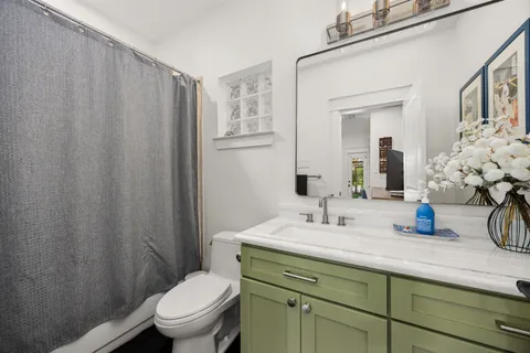a living room with fireplace furniture and a large window