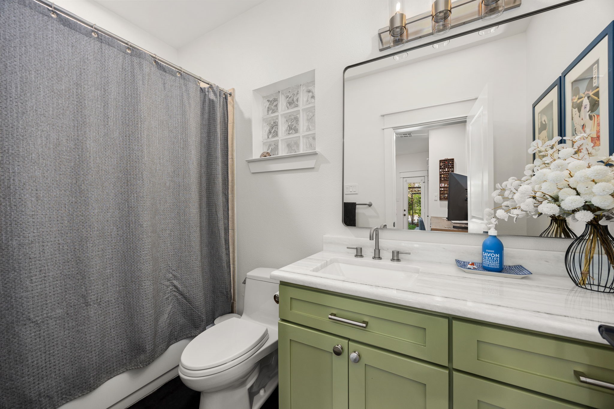 523 Fowler Street Houston, TX 77007 - Photo 8 of 39 a bathroom with a granite countertop sink vanity mirror and toilet