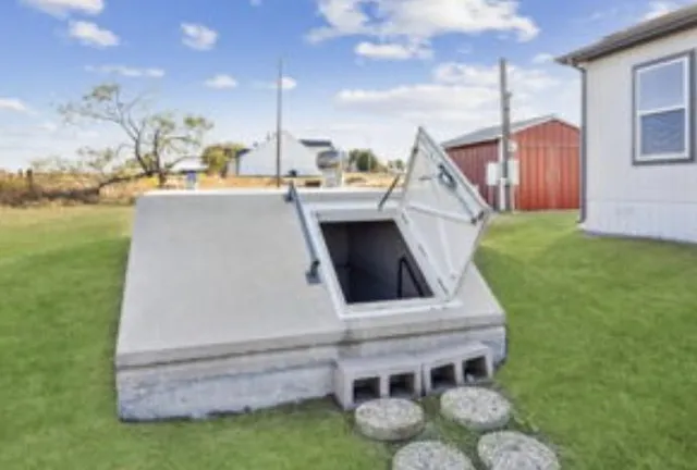 a view of a lake with a big yard and a large tree