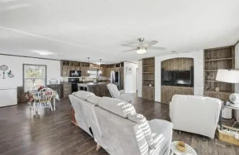 a living room with furniture and kitchen view
