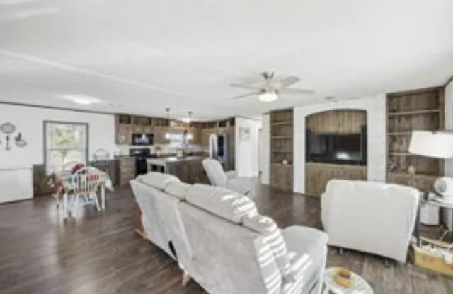 a living room with furniture and kitchen view