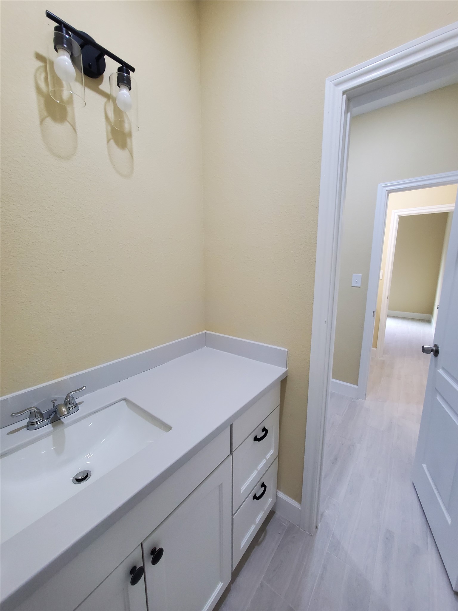 1306 North 9th Street Conroe, TX 77301 - Photo 18 of 47 a bathroom with a sink and vanity