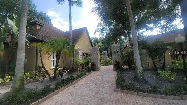 a view of a house with brick walls and potted plants