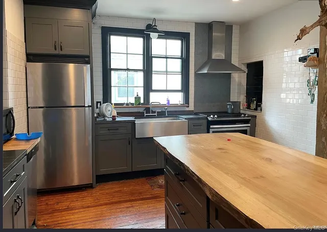 a kitchen with a refrigerator a stove a sink dishwasher and a refrigerator