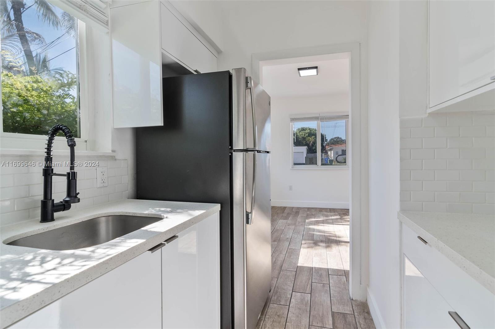 2190 Southwest 14th Terrace, Unit 1 Miami, FL 33145 - Photo 4 of 13 a kitchen with a refrigerator and a sink