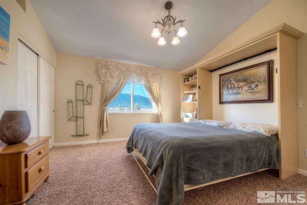 2160 Antelope Valley Road Reno, NV 89506 - Photo 12 of 25 a bedroom with a bed and a chandelier