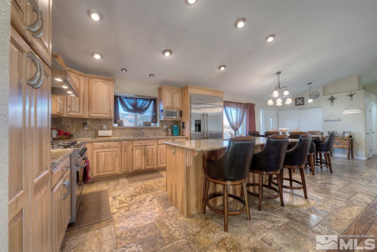 2160 Antelope Valley Road Reno, NV 89506 - Photo 3 of 25 a kitchen with kitchen island granite countertop wooden cabinets a counter top space and stainless steel appliances