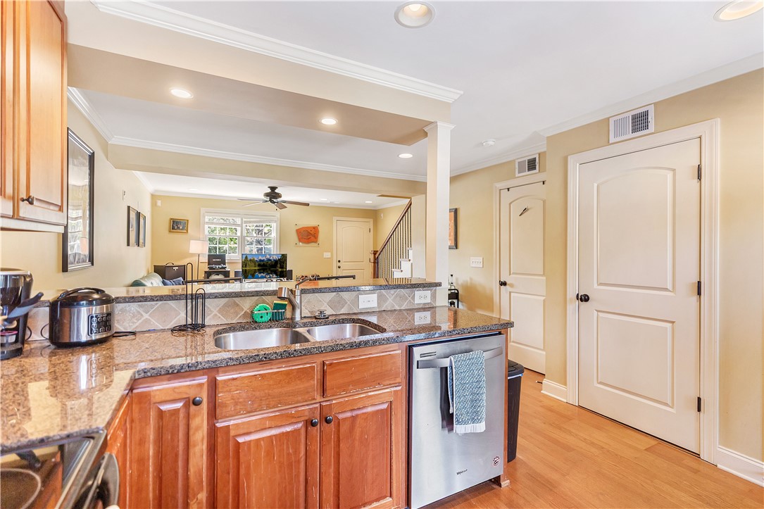 209 Calhoun Street Clemson, SC 29631 - Photo 11 of 25 Granite countertops and rich wood cabinetry anchor this functional open kitchen.