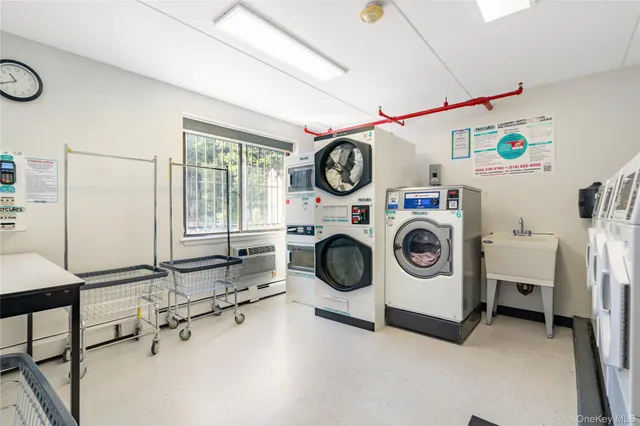a utility room with dryer washer and a view of living room