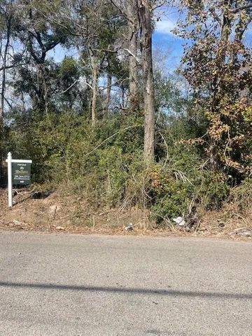 a white house with trees in the background