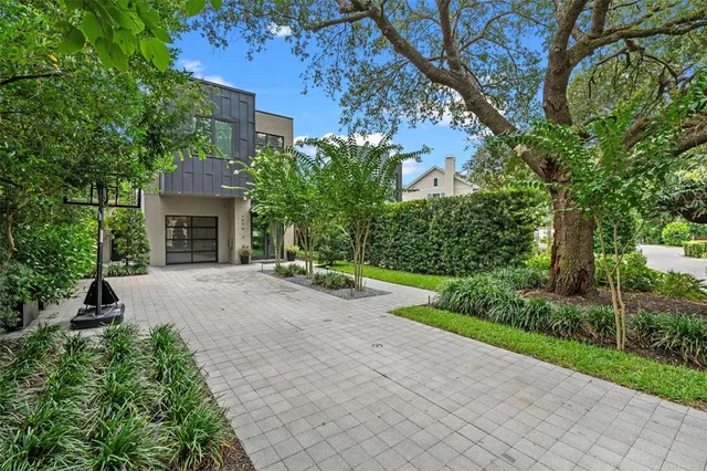 a front view of a house with yard and green space