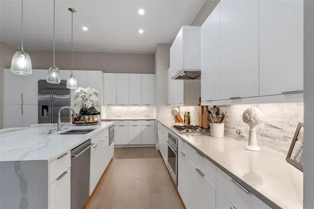 a kitchen that has a sink and a stove in it