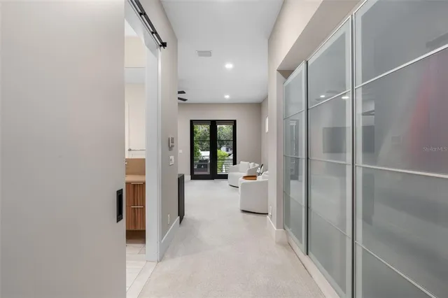 a view of a balcony with chairs and wooden floor
