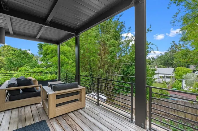 a view of balcony with chairs and wooden floor