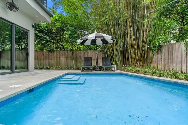 an aerial view of residential house with outdoor space and trees all around