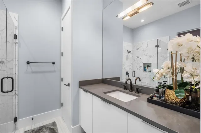 a backyard of a house with table and chairs under an umbrella