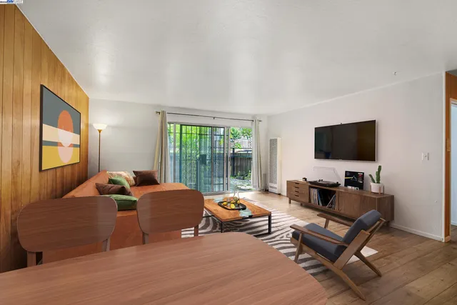 a living room with furniture window and a flat screen tv