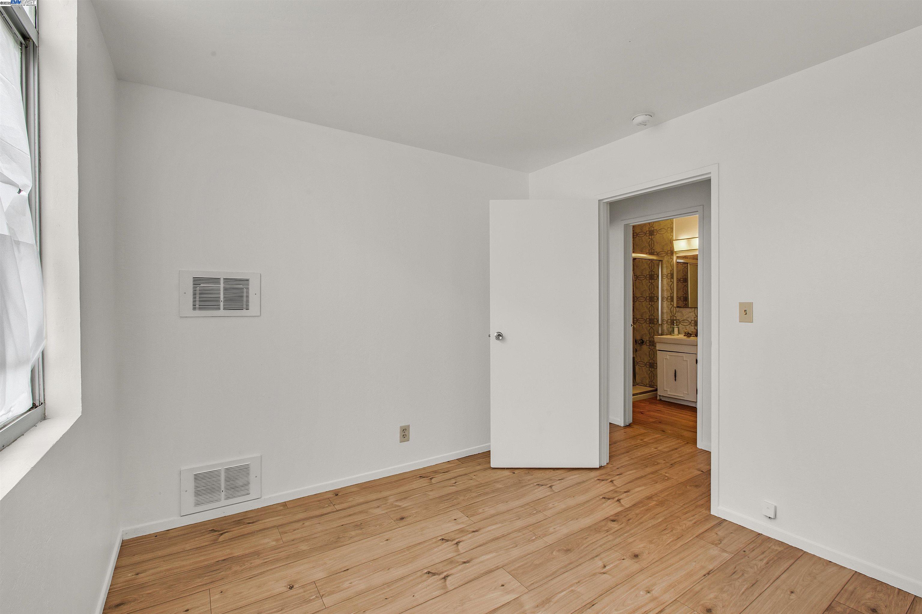 1540 O'Farrell Street, Unit 1 San Francisco, CA 94115 - Photo 8 of 19 a view of room with wooden floor and window