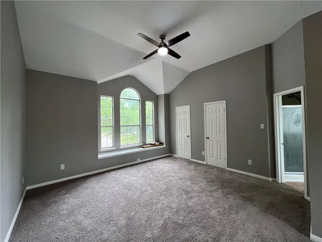 a view of a livingroom with a ceiling fan and window