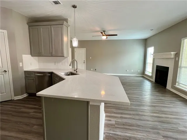 a view of a kitchen center island wooden floor and staircase